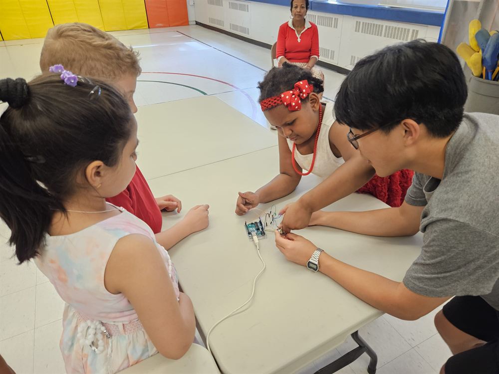 Elementary school students trying robotics at the Dublin Heights event